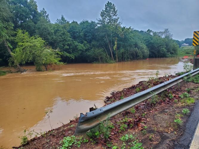 Big Clouds Creek is swollen at the bridge on Crawford-Smithonia Road on Wednesday morning after days of heavy rain. Several dirt roads and fords are underwater throughout the county. (Submitted Photo)