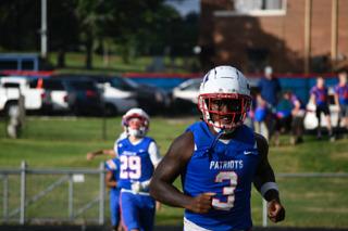Senior O'Maury Huggs participates in warm ups before the Patriots’ 30-27 victory over East Hall last Saturday. He played both defensive end and running back in the game. (ANDY MATHIS/THE OGLETHORPE ECHO)