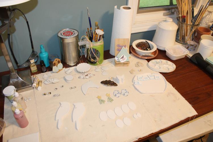 Ceramic pieces rest in Massey's home studio in Arnoldsville, Georgia, on Aug. 28, 2025. Massey makes multiple pieces at a time; they are rolled out in clay, fired, glazed, fired again and painted on before finally going in the kiln one last time to be completed. (Photo/Emily Adams)