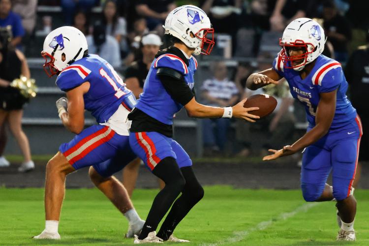 Oglethorpe County quarterback Caden Hartrum (1) hands the ball off to Oglethorpe County running back Zion Pass (7) during Oglethorpe County’s game against the East Hill Vikings at Oglethorpe County High School on Saturday, Aug. 23, 2025. Pass ran the ball into the end zone for a Patriots touchdown. (Photo/Sofia Yaker, The Oglethorpe Echo))