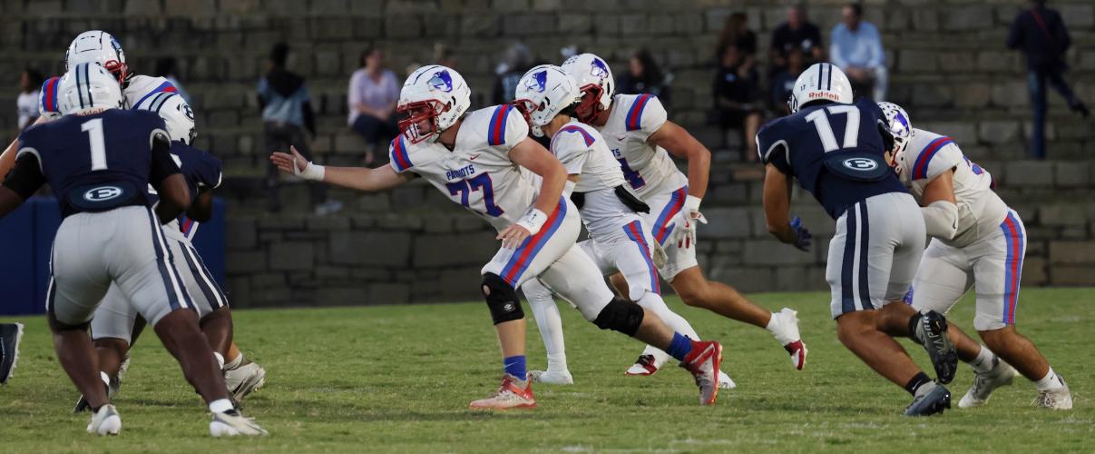 Oglethorpe County High School junior Jake Huff (77) goes to tackle Elbert County High School senior Reunte Tucker (1) alongside teammates during the Granite Bowl on Friday, Sept. 19, 2025. (Photo/Amelia Durden)