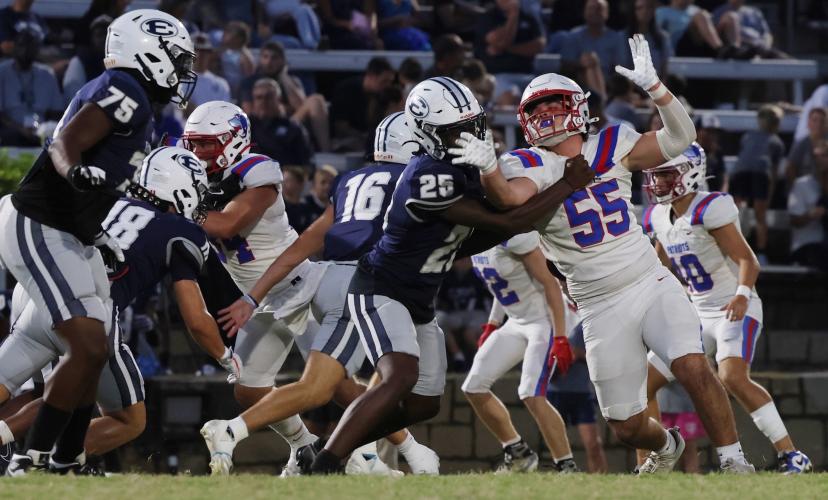 Oglethorpe County High School sophomore Coleton Sexton (55) reaches to catch a football while being tackled by Elbert County High School junior Brayden Lyon (22) in the Granite Bowl on Friday, Sept. 19, 2025. (Photo/Amelia Durden)