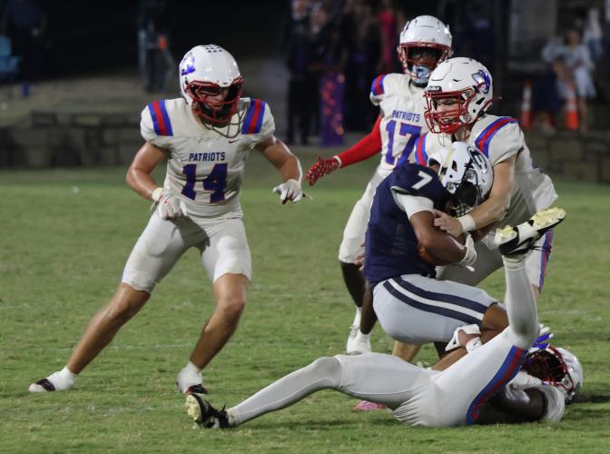 Oglethorpe County High School senior Keagan Moats (20), junior Jackson Tatum (14) and junior Rico Howard (17) tackle Elbert County High School senior Jose Rodriguez (7) at the Granite Bowl on Sept. 19, 2025. (Photo/Frank Lowery)