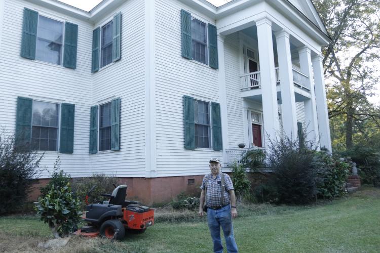 John Buckman, longtime Philomath resident and member of the Philomath Church Preservation Association, stands in front of his house on Sept. 15, 2025. This house is the sister house to the Globe, which is located next door, and has only been lived in by five families. (Photo/Ansley Gavlak)