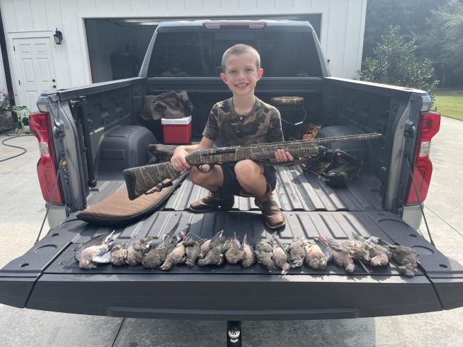 Young hunter Tate McDonald with his new shotgun and some of the doves he shot on Saturday at the Nation Family Farm. McDonald had a banner day in the field this year. Courtesy photo by Johnny Ralston (Submitted Photo/The Oglethorpe Echo).