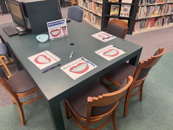 Children learned about dental hygiene at the Oglethorpe County Library Family Health Resource Fair on Saturday, Aug. 30, 2025. Using a toothbrush and a dry-erase marker, participants cleaned drawings of teeth as a visual lesson in proper care. (Photo/Maura Rutledge)
