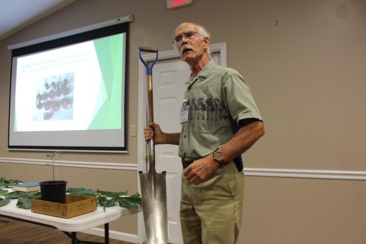 Geoff Hill demonstrates how he digs a hole to prepare for the planting of pawpaw trees on Monday, Sept. 6, 2025, at the Georgia Farm Bureau in Crawford. Hill has been growing pawpaw on his land for several years. (Makenna Reavis/The Oglethorpe Echo)
