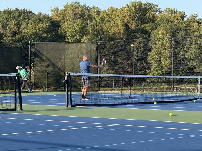 COOPER HUAU/THE OGLETHORPE ECHO Lloyd Martin returns a volley as part of a drill in his later class for the adults.