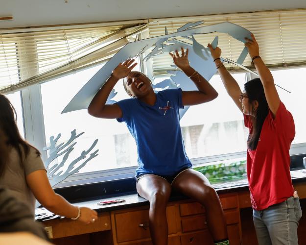 OCHS juniors Mya Jewell and Isabel Rios laugh as they create the decorations for homecoming week on Friday, Aug. 29, 2025. For many on the council, the decorations are their favorite part of festivities.(Photo/Drew Bearden)