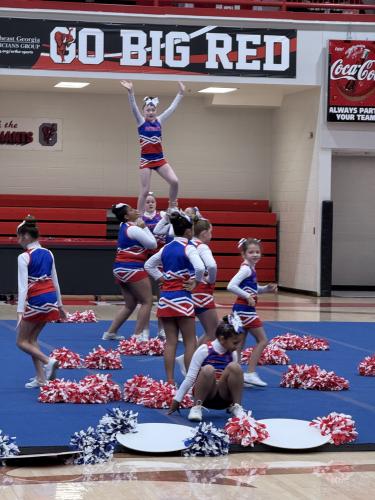 The Oglethorpe County Recreation Department’s 12u squad performs a lift at the end of its performance. The team won its age group at the Big Red Cheer Classic in Gainesville on Oct. 26. (Cooper Huau/The Oglethorpe Echo)