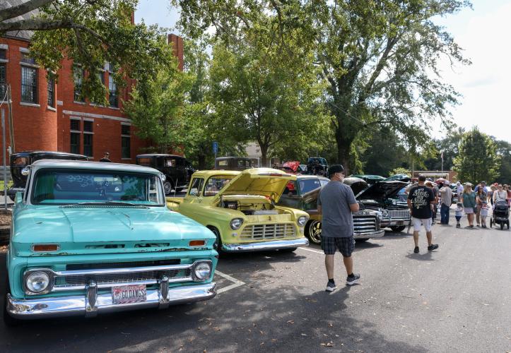 Attendees walk through the display of cars, trucks, tractors and motorcyles at the Firefly Cruise-In in Lexington, Georgia on Sunday, Sept. 28, 2025. This is the 14th year that the cruise-in has taken place. (Photo/Susanna Johnson)
