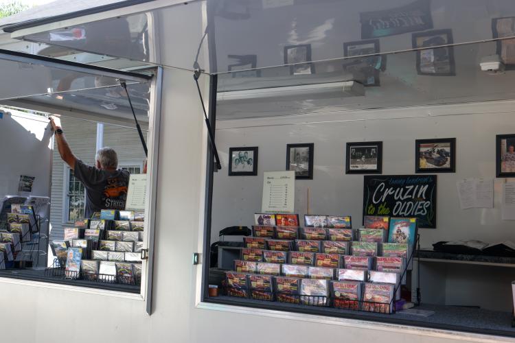 Tommy Landrum, DJ and emcee for the Firefly Cruise-In, speaks to attendees from inside his truck in Lexington, Georgia on Sunday, Sept. 28, 2025. Landrum, who lives in Winterville, runs a professional DJ company called "Cruzin' to the Oldies" and travels to various car shows and cruise-ins to play music from the 1950s to early 1970s. (Photo/Susanna Johnson)