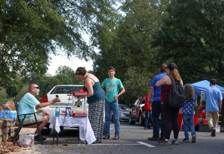 Attendees purchase baked goods and snacks from a table at the Firefly Cruise-In in Lexington, Georgia on Sunday, Sept. 28, 2025. The event ran from 1 p.m. to 5 p.m. and was hosted by the Oglethorpe County Chamber of Commerce. (Photo/Susanna Johnson)