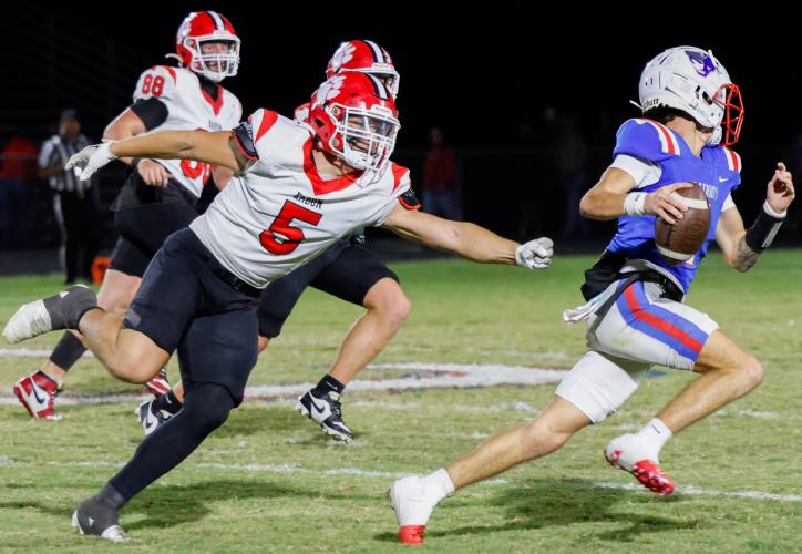Oglethorpe County quarterback Caden Hartrum eludes the grasp of Rabun County’s Dane Tyler (No. 5) during the Patriots’ 28-19 upset of the fifth-ranked Wildcats on Friday night at Patriot Stadium. Hartrum threw two touchdown passes and ran for another in the Patriots’ first Region 8-A Division I win of the season. (Photo/Caroline Newbern)