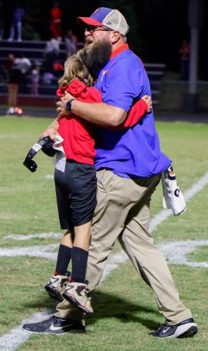 Offensive coordinator Josh Austin celebrates Oglethorpe County High School football's win against Rabun County High School with his son. OCHS won 28-19. (Photo/Caroline Newbern)