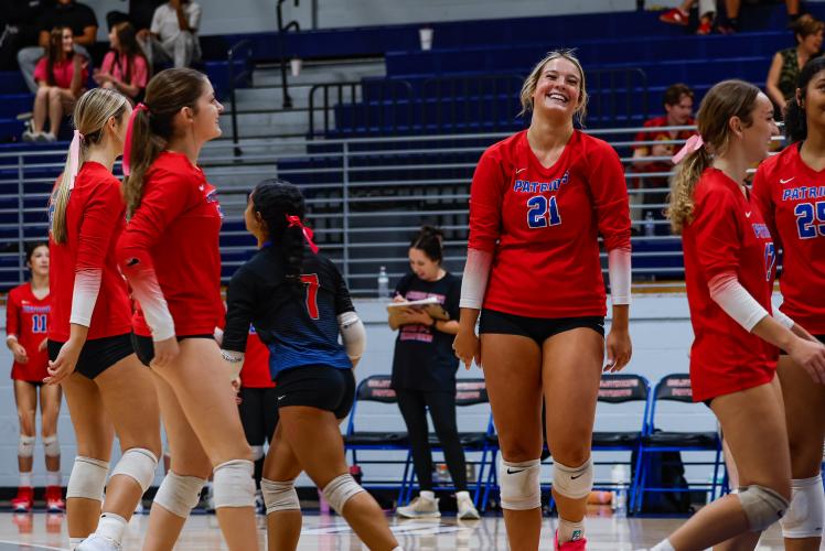 Senior Elizabeth Cook celebrates with her team after scoring a point in a playoff game vs Commerce high school. (Photo/Drew Bearden)