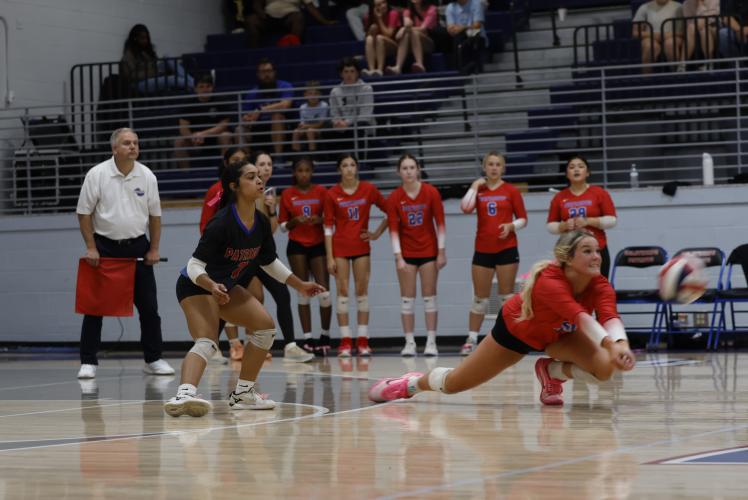 Senior Elizabeth Cook digs the ball during the playoff game vs Commerce to save the point. (Photo/Drew Bearden)