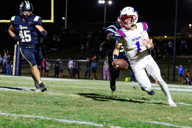 DREW BEARDEN/THE OGLETHORPE ECHO Oglethorpe County’s Caden Hartrum scrambles away from Commerce players on Friday. Hartrum threw a touchdown pass in the 24-14 victory.