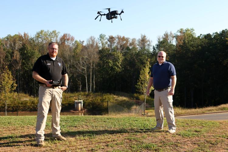 Oglethorpe County EMS director Josh Robinson (left) and Emergency Management Agency director Douglas Spencer send the Teledyne FLIR SIRAS drone up for a flight in Lexington last week. They are the county’s two licensed drone pilots. (Katherine Davis/The Oglethorpe Echo)