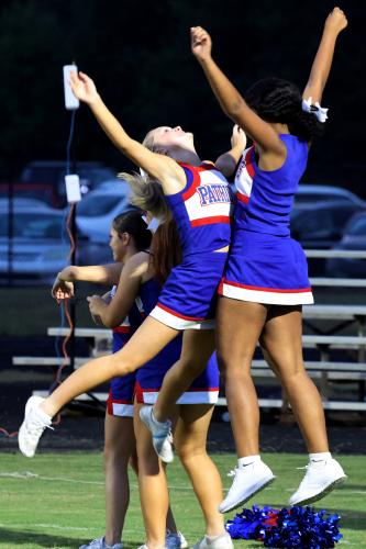 Two cheerleaders for Oglethope High School chest bump before the football game begins against Athens Academy on Friday, Sept. 26, 2025, in Lexington, Georgia. (Photo/Emma Peterson)