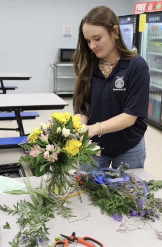 Callie Bridges, a senior at Oglethorpe County High School, works on her arrangement during the floral design contest Thursday. Bridges won first place in the senior division. (Photo/Ella Jones)