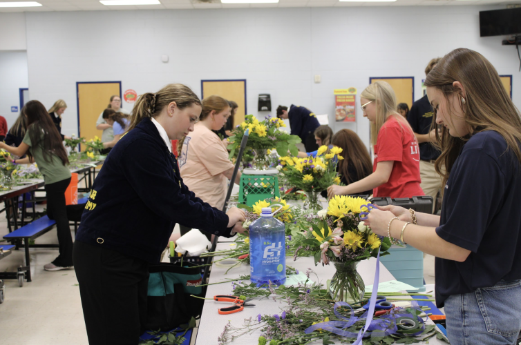 Oglethorpe County’s Callie Bridges (right) and other students work on their entries during the floral design portion of the Area 2 contest at OCHS on Sept. 25. Bridges won the competition.