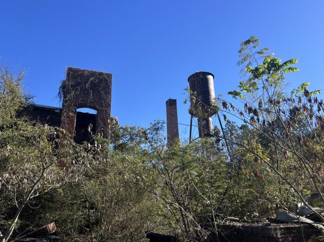 The property includes a water tower and several tall brick structures. This is part of the Historic Jefferson Mill property in Crawford that went up for sale in October of 2025 for $1.6 million. (Makenna Reavis/The Oglethorpe Echo)