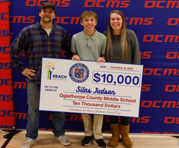 Silas Judson stands with his family following the REACH signing ceremony at Oglethorpe County Middle School on Friday, Nov. 14, 2025. His mother said his progress has been “a complete 180,” reflecting years of growth and determination. (Photo / Drew Bearden)
