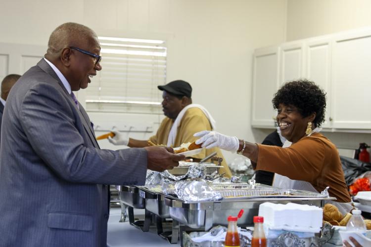 Elouise Clark and her husband Sammy Clark (in the background) serve lunch to attendees at St. Paul Methodist Church in Lexington on Sunday, Nov. 16, 2025. The Clarks were instrumental in the reopening of St. Paul's doors. (Photo/Susanna Johnson)