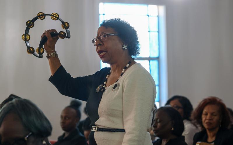 Christine Eberhart shakes a tambourine during worship at St. Paul Methodist Church in Lexington on Sunday, Nov. 16, 2025. Eberhart grew up within walking distance of St. Paul and said it "feels like home" to be back. (Photo/Susanna Johnson)