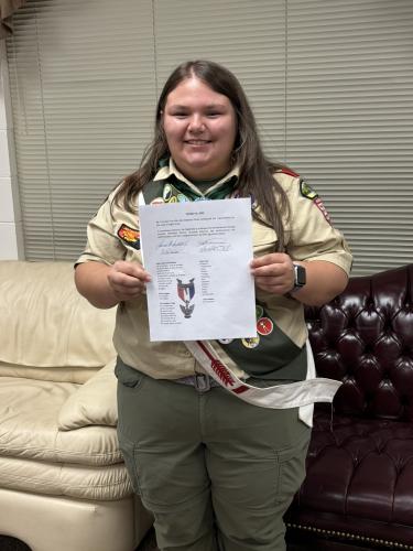 Madelyn Flores stands proudly with her Eagle Scout certificate on Oct. 16, 2025. Flores recieved the honor with the help of her troop, friends and family. (Submitted Photo)