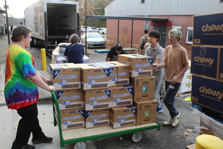 OCHS students help unload the Northeast Georgia Food Bank truck in preparation for the food pantry at OCHS on Nov. 20. Jodie Zeuke, who has been directing the food pantry since 2015, said it provides a variety of goods like produce, frozen foods and toilet paper. (Hannah Freeman/The Oglethorpe Echo)