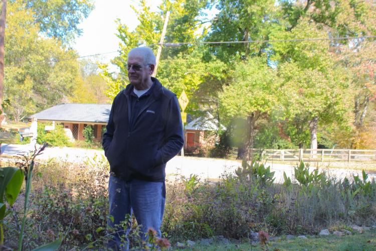 Dr. William Hudson stands in his front yard on Nov. 4, 2025, in Winterville, Ga. Hudson uses his home as a research site, observing local Joro spider populations and their behaviors. (Gabrielle Gruszynski/The Oglethorpe Echo)