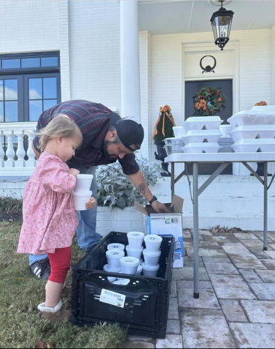 Rob Findley and Jillian Moore organize food at last year's Thanksgiving lunch at the Colbert-Benton Guest House. Organizer Flo Hix said 300 people were served in 2024.