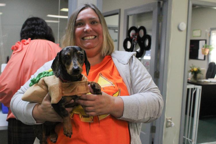 Oglethorpe County Senior Center visitor Shanna Harris holds Stetson to show off his hot dog costume at the center's Halloween costume party. Stetson has been coming to the center since he was 8 weeks old. (Hannah Freeman/The Oglethorpe Echo)