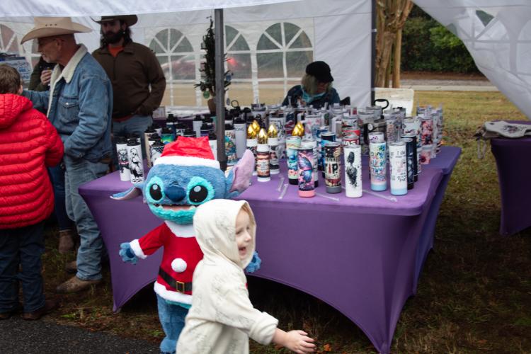Edwin Cowherd notices the Christmas Stitch at PF Creations Gift Shop. This gift shop sells an assortment of sublimation tumblers, bluetooth speaker tumblers, bullet tumblers and water bottles. (Grace Burnett/ The Oglethorpe Echo)