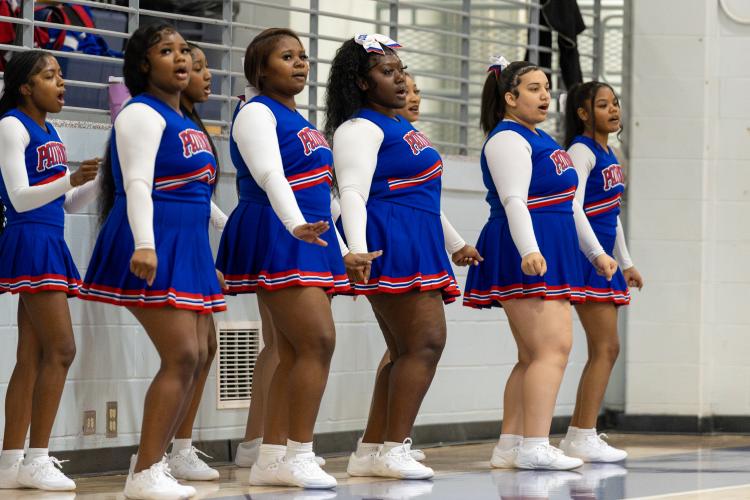 Members of the OCHS basketball cheer squad, including (from left) Shyanne Spade, Za’Nijha Carter, Zariah Johnson (partially hidden back row), Ambreia Kelley, Tori Clark, Kyra Edwards (partially hidden back row), Shayla Richardson and Krysten Jones encourage the Patriots during a game last week. Clark comes up with the cheers and helps teach the routines. (Photo/Ty Johnston)