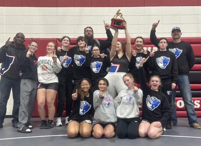 Coach Josh Austin (back middle) and the OCHS girls wrestling team won the area dual title last year, a feat he hopes to build on this season. He has to be flexible with his roster since there are only 14 girls on the team. (Submitted Photo)