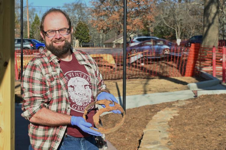 Jonathan Scott, Winterville’s cultural heritage director, holds a metal artifact earlier this month. The city plans a nearly year-long celebration of the country’s 250th anniversary. (Neva Drane/The Oglethorpe Echo)
