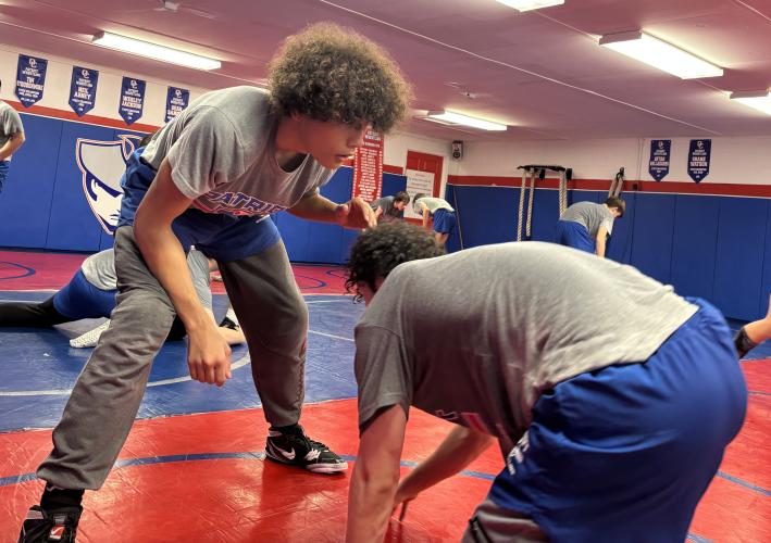 Damien Suarez (left) works on drills with teammate Logan Bruce during the boys wrestling team’s practice on Monday. Suarez is 19-15 at 120 pounds in just his second year wrestling. (Photo/Andy Johnston)