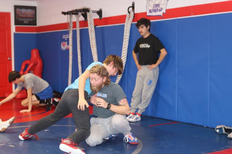 Oglethorpe County Middle School (OCMS) head wrestling coach Cory Collins and OCMS student Sawyer Pittard work on a drill together at the Oglethorpe County High School gymnasium on. Pittard was brought up to train with the high school team after his season finished. (Photo/Grant Turnage)