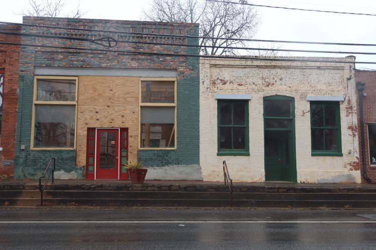 Owner of six buildings in Lexington, Rick Hawkins, has made repairs to two of the four for sale. New roofs have been installed to the buildings 110 (right) and 112 Main St. (left). (Photo/Finley Millwood)