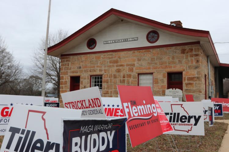 Campaign signs fill the yard outside the Historic Crawford Depot during the GOP rally on Jan. 24. Many candidates running for state and federal office attended the rally. (Photo/Riley Baugh)
