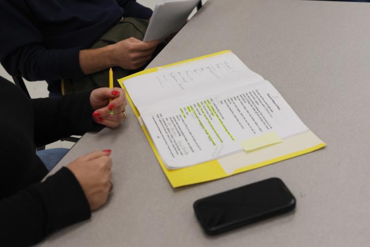 Director and performer Penny Miller takes notes on her script as she rehearses a scene for "Almost, Maine" last week. Arts! Oglethorpe will perform the play on Feb. 20-21, with Miller acting and directing numerous scenes. (Photo/Addison Simmons)