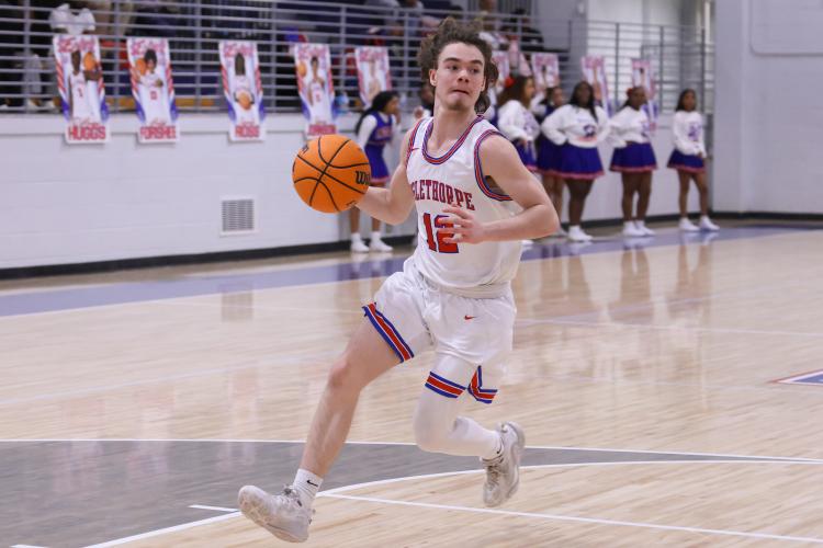 Oglethorpe County player Jackson Harrison dribbles the ball down the court on Feb. 10. The Patriots lost to the Blue Devils with a score of 54-72. (Photo/Addison Simmons)