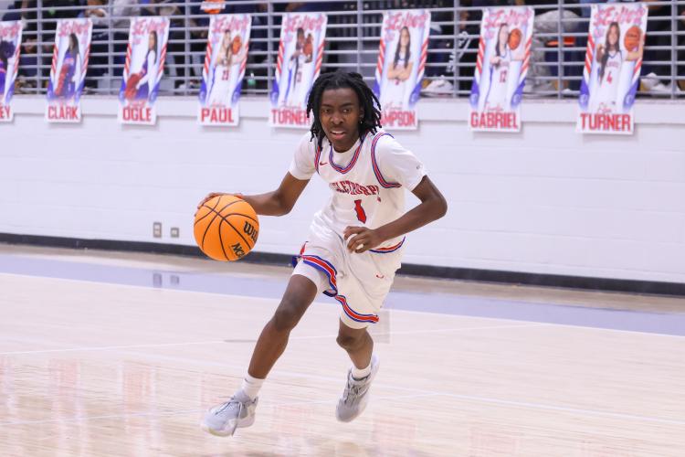 Oglethorpe County player Isaiah Ross dribbles down the court on  Feb. 10. The Patriots lost to the Blue Devils with a score of 54-72. (Photo/Addison Simmons)