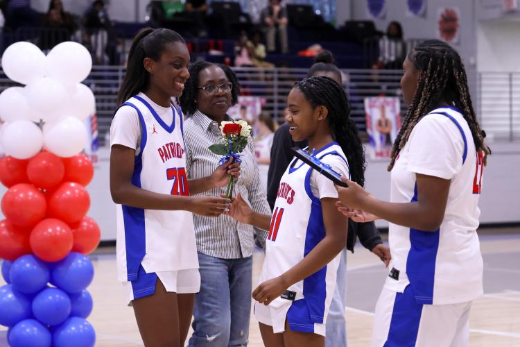 Jaliyah Glenn gives flowers to Jaliyah Turner at the Oglethorpe County High School gymnasium on Feb. 10. The Patriots honored their seniors during their game against Elbert County. (Photo/Addison Simmons)