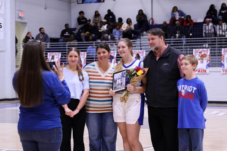 Ansley Paul poses with family for a photo at the Oglethorpe County High School gymnasium on Feb. 10. The Patriots honored their seniors during their game against Elbert County. (Photo/Addison Simmons)