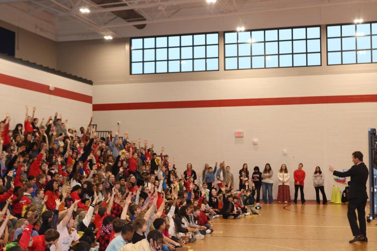 Students raise their hands as magician Michael Boone asks for a volunteer for his next trick. Magic tricks kept the students engaged during the Reading Rally. (CHARLOTTE COCHRAN/THE OGLETHORPE ECHO)