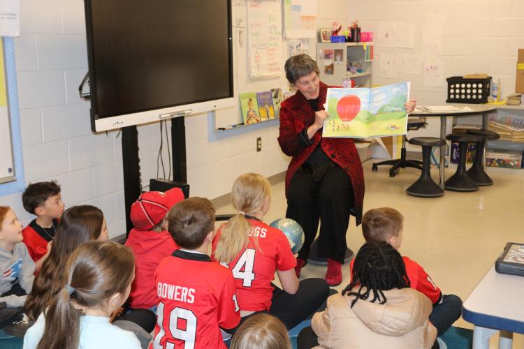 Former OCES principal Nancy Hart reads to Mary Kate Shealy’s third-grade class on Feb. 4. Hart accompanied her story with a globe and asked students questions, making the read-aloud interactive. (CHARLOTTE COCHRAN/THE OGLETHORPE ECHO)
